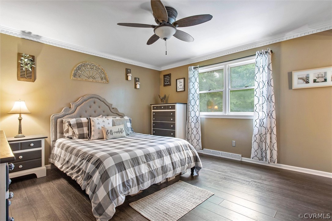 12808 Middlebrook Road Chester, VA 23831 - Photo 26 of 35 a bedroom with a large bed and a chandelier fan