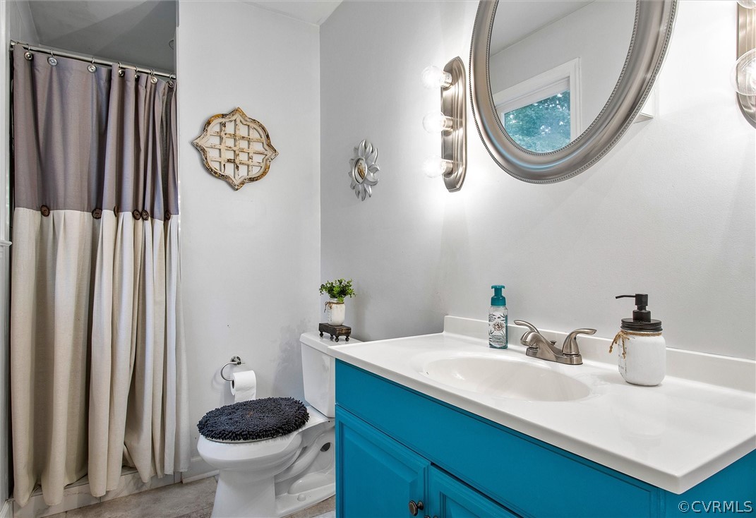 12808 Middlebrook Road Chester, VA 23831 - Photo 28 of 35 a bathroom with a toilet a sink and a mirror