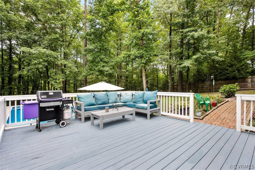 12808 Middlebrook Road Chester, VA 23831 - Photo 32 of 35 a roof deck with table and chairs under an umbrella with wooden floor