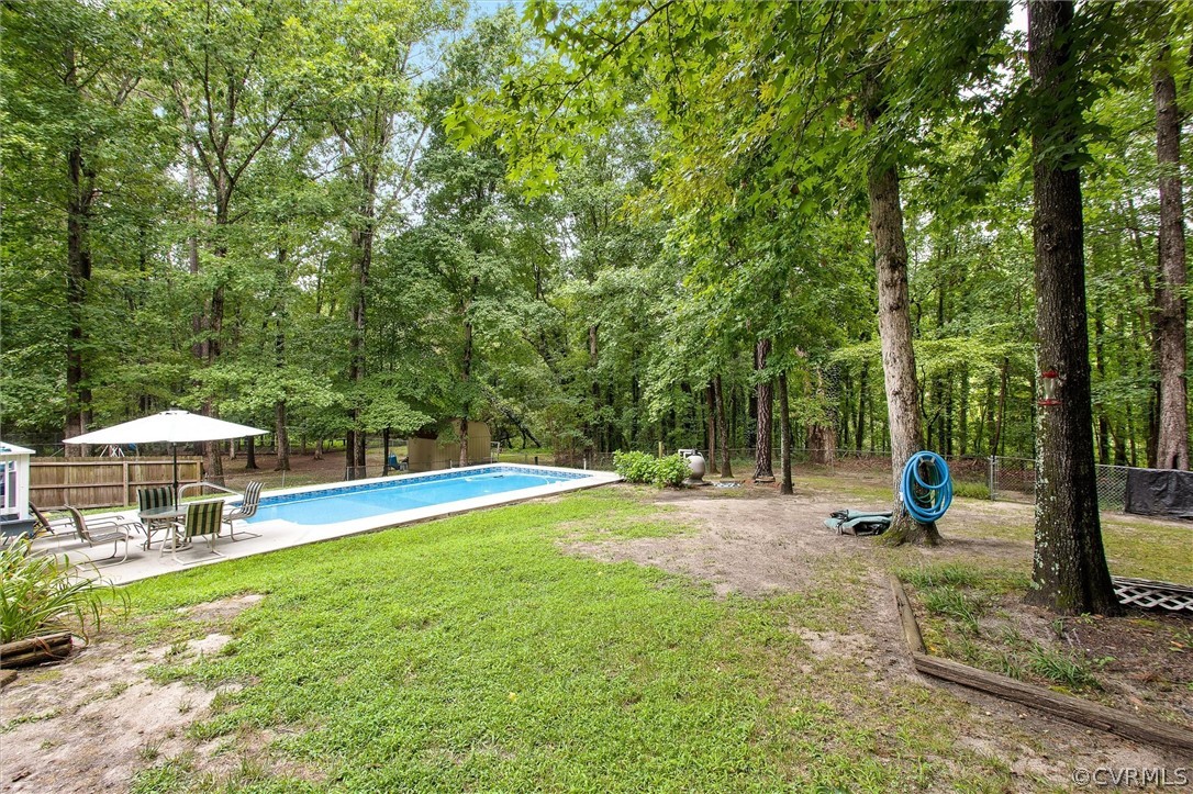 12808 Middlebrook Road Chester, VA 23831 - Photo 33 of 35 a view of a swimming pool with a patio and a yard