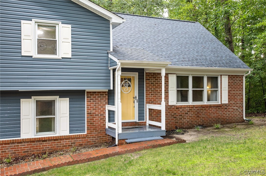 12808 Middlebrook Road Chester, VA 23831 - Photo 4 of 35 a front view of a house with garden