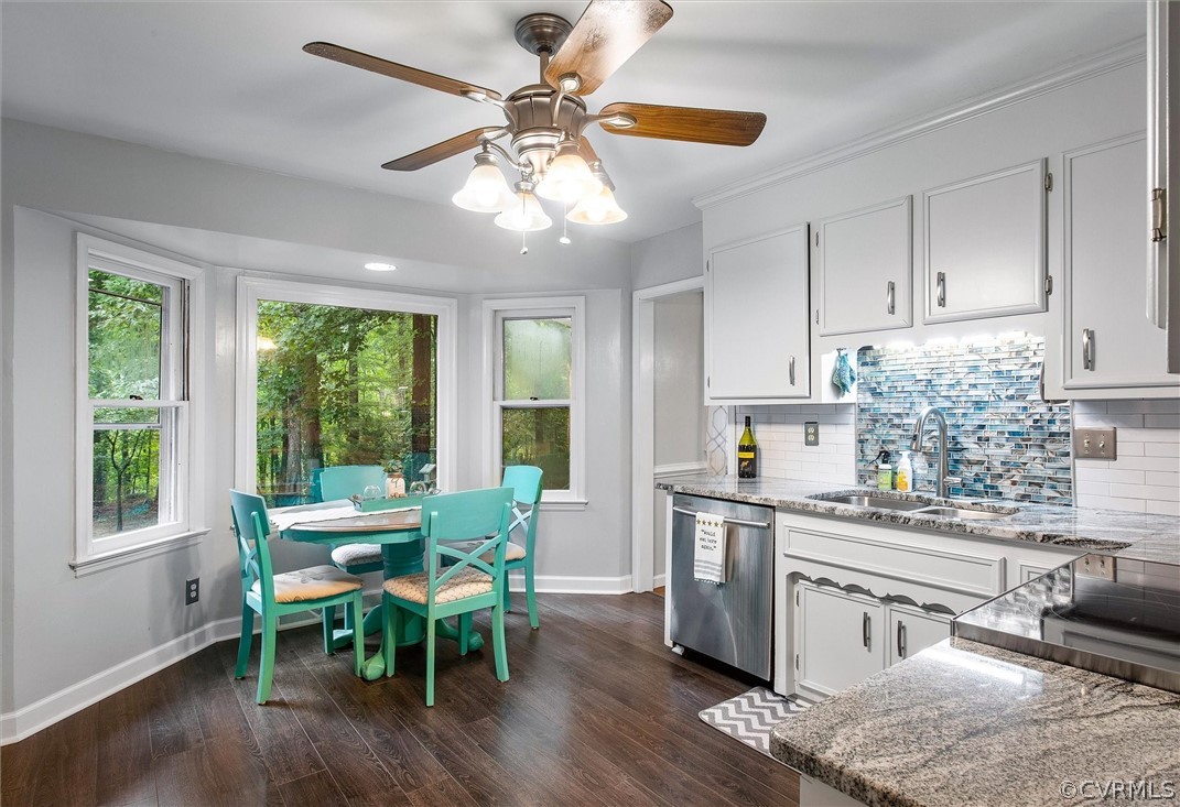 12808 Middlebrook Road Chester, VA 23831 - Photo 7 of 35 a kitchen with stainless steel appliances granite countertop wooden floor dining table and chairs