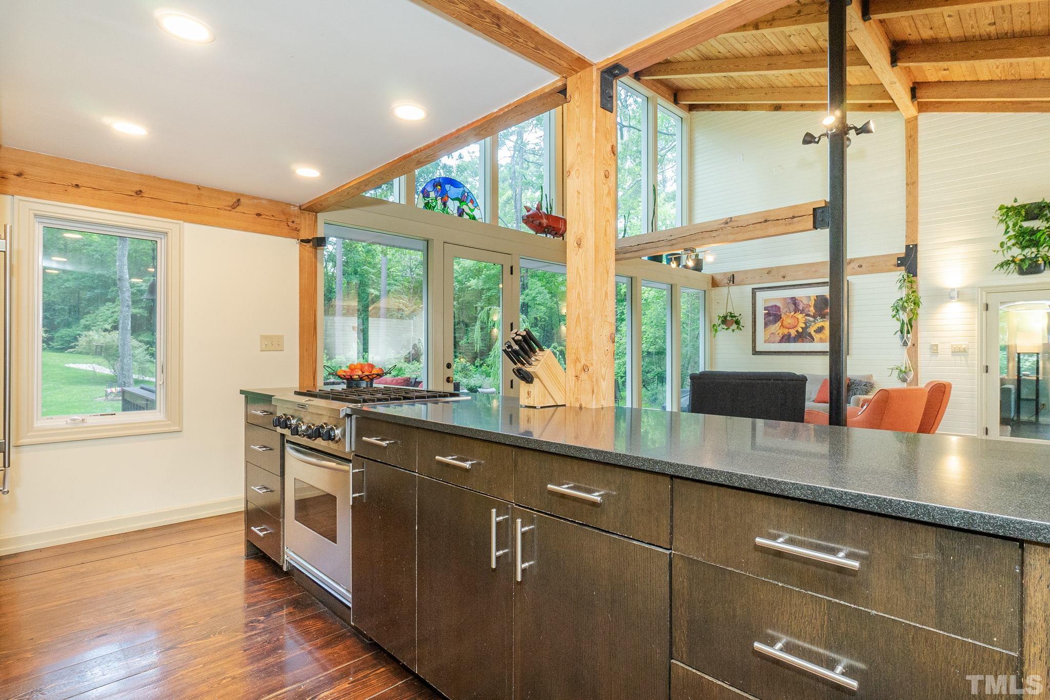 5215 Friends School Road Durham, NC 27705 - Photo 12 of 39 a kitchen with stainless steel appliances wooden cabinets a sink and a large window