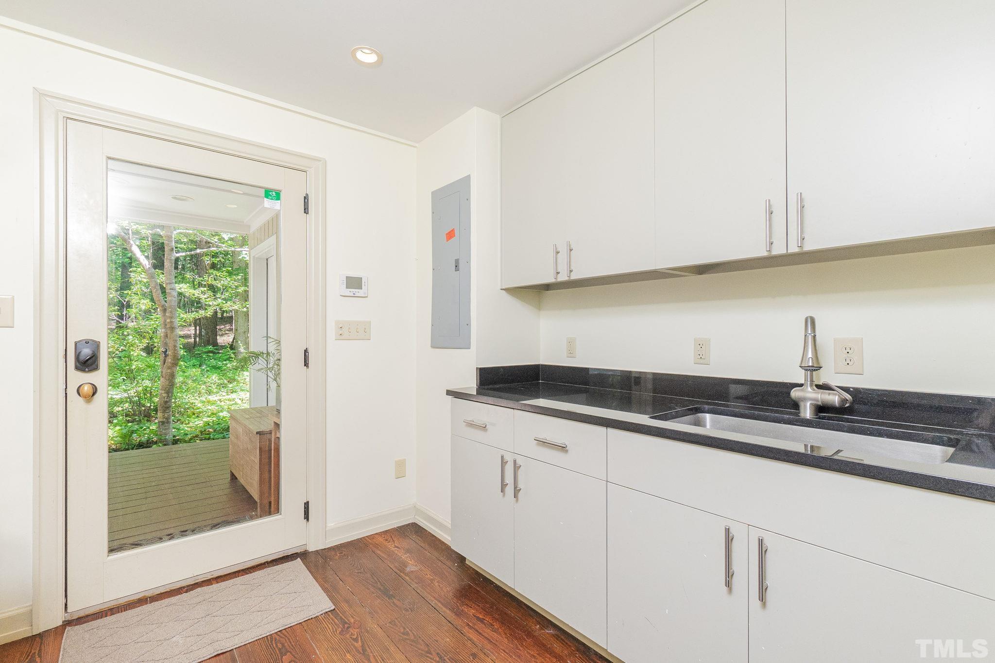 5215 Friends School Road Durham, NC 27705 - Photo 19 of 39 a kitchen with granite countertop white cabinets and white appliances