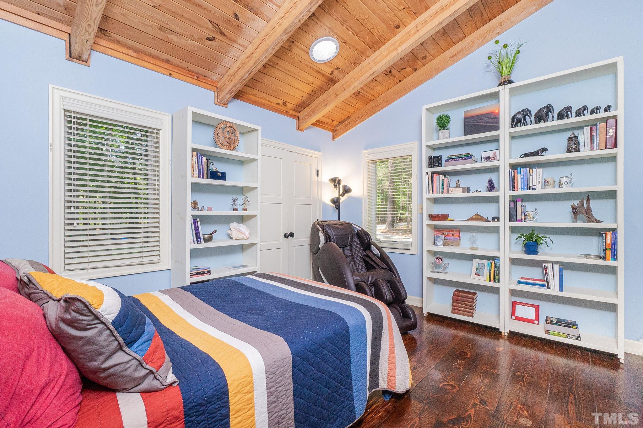 5215 Friends School Road Durham, NC 27705 - Photo 21 of 39 a bed room with a bed and a book shelf