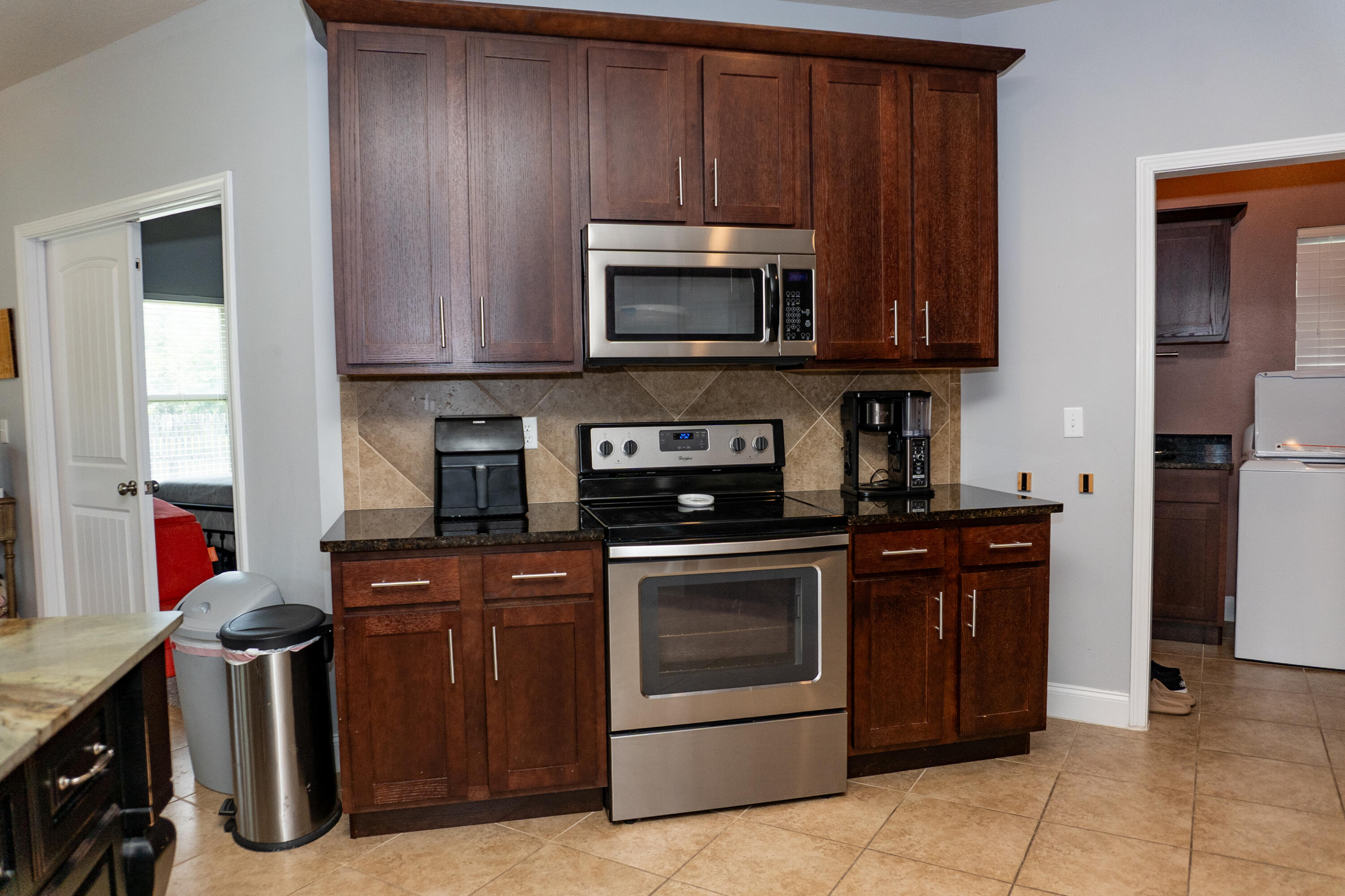 4517 Beth Circle Crestview, FL 32539 - Photo 13 of 45 a kitchen with stainless steel appliances granite countertop a stove and a microwave