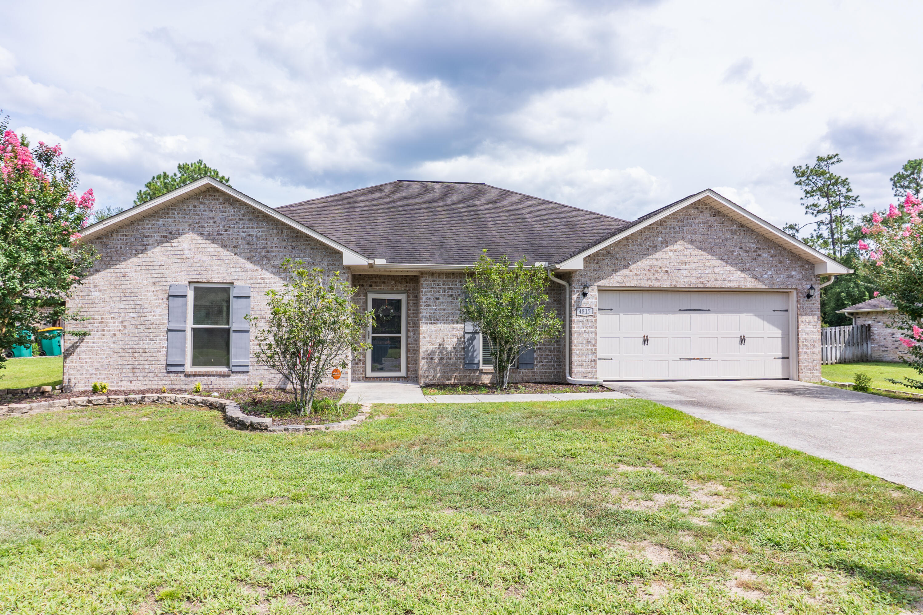 4517 Beth Circle Crestview, FL 32539 - Photo 2 of 45 a front view of a house with a garden and yard