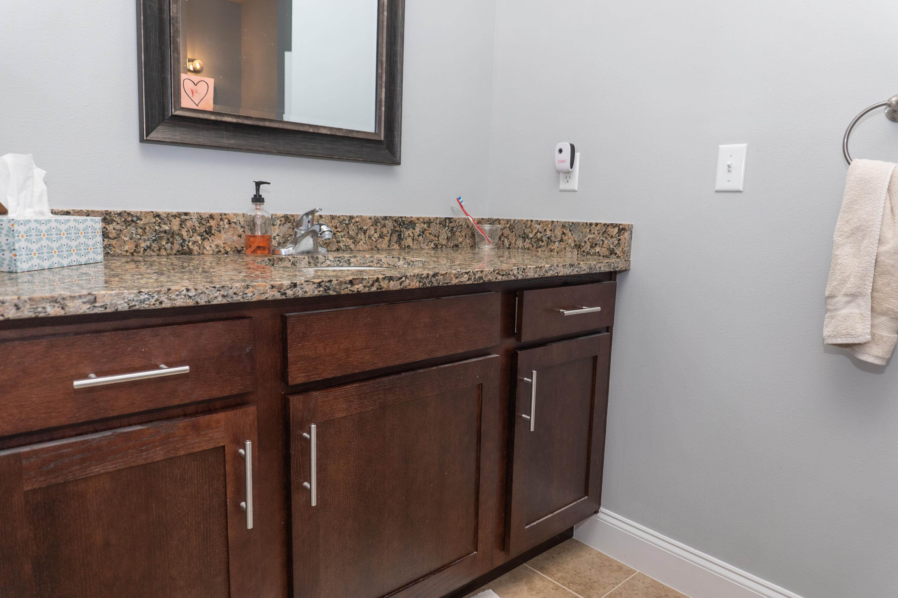 4517 Beth Circle Crestview, FL 32539 - Photo 21 of 45 a bathroom with a granite countertop sink and a mirror