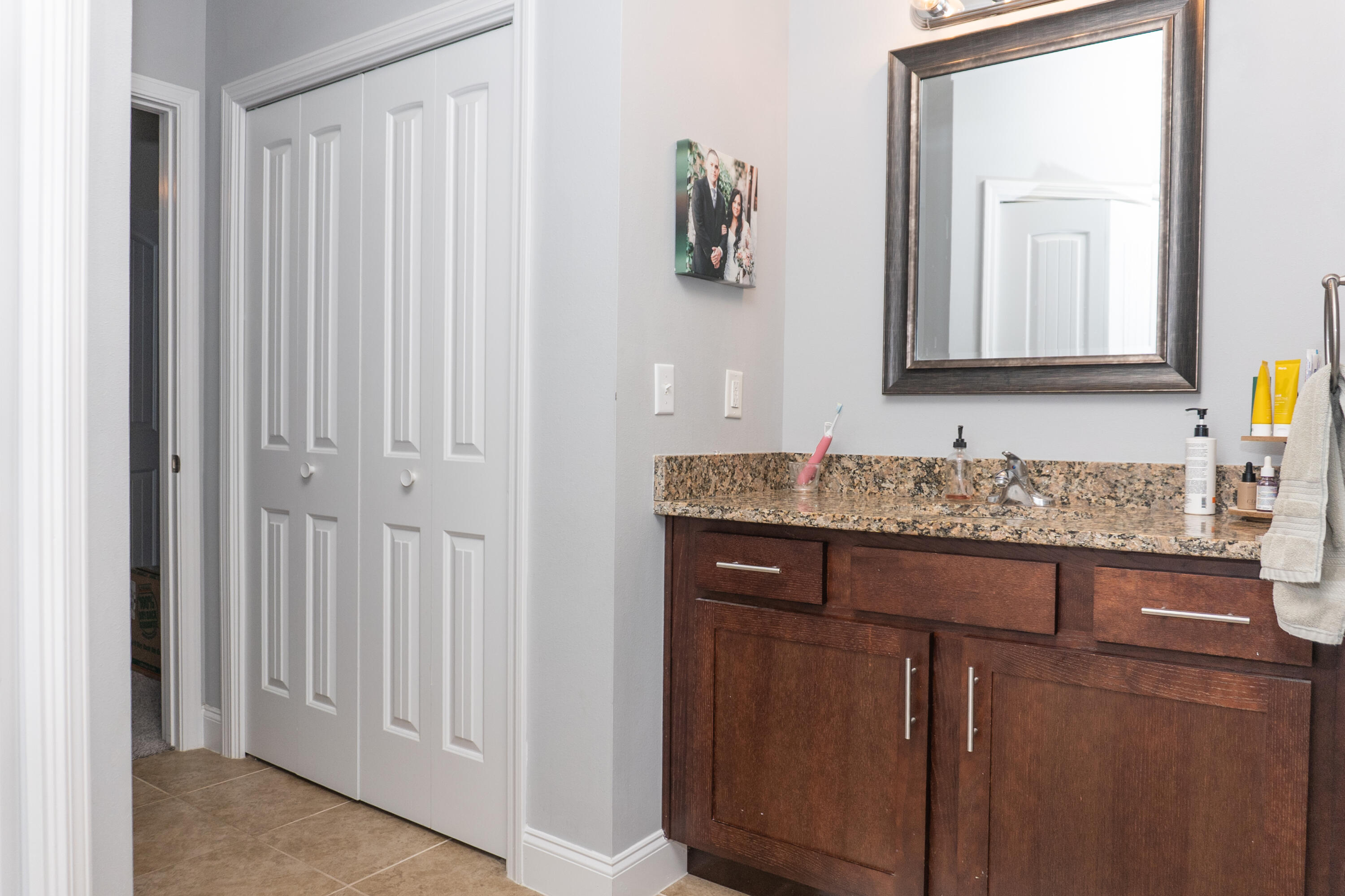 4517 Beth Circle Crestview, FL 32539 - Photo 26 of 45 a bathroom with a granite countertop sink and a mirror