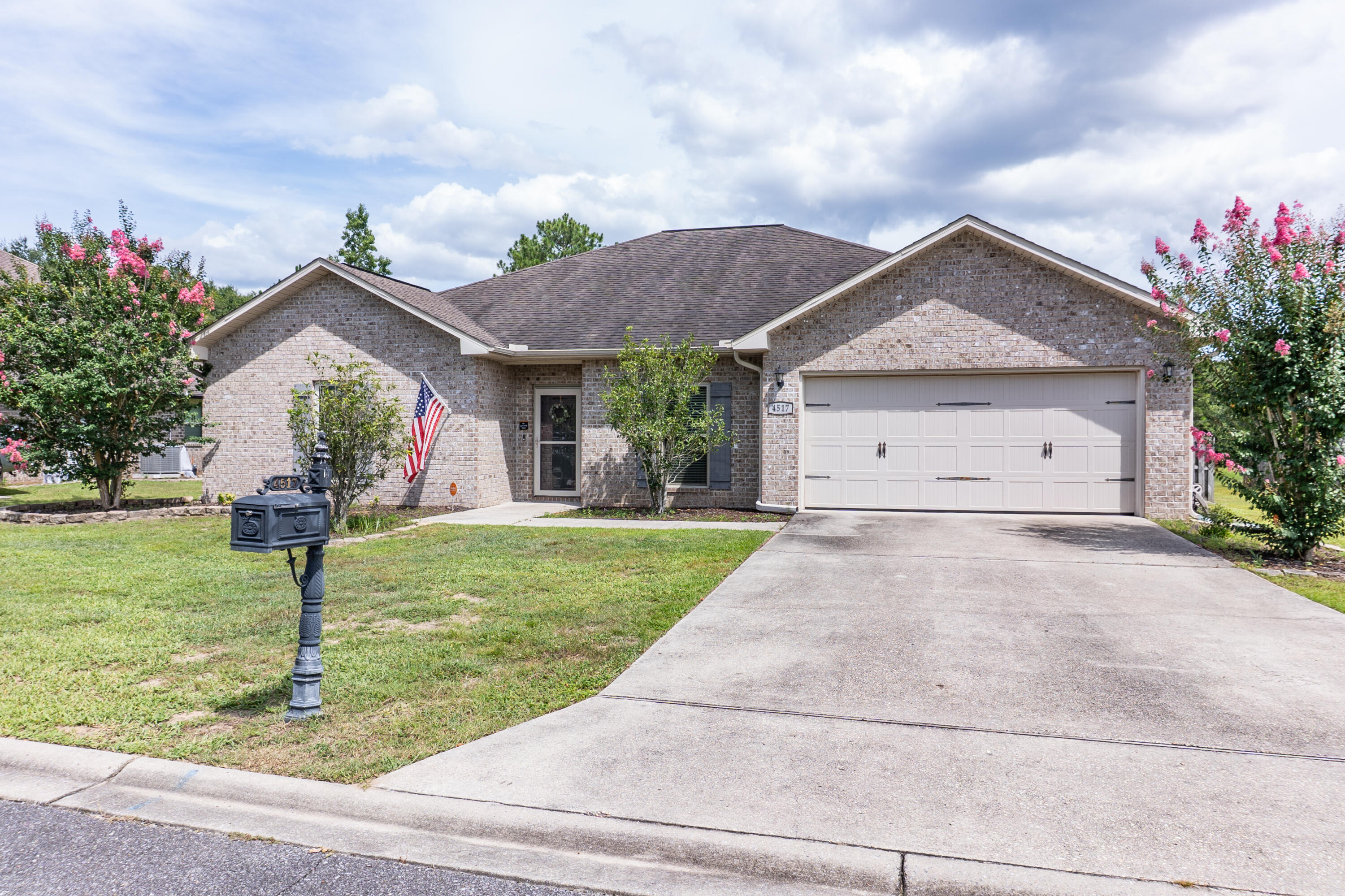 4517 Beth Circle Crestview, FL 32539 - Photo 3 of 45 a front view of a house with garden