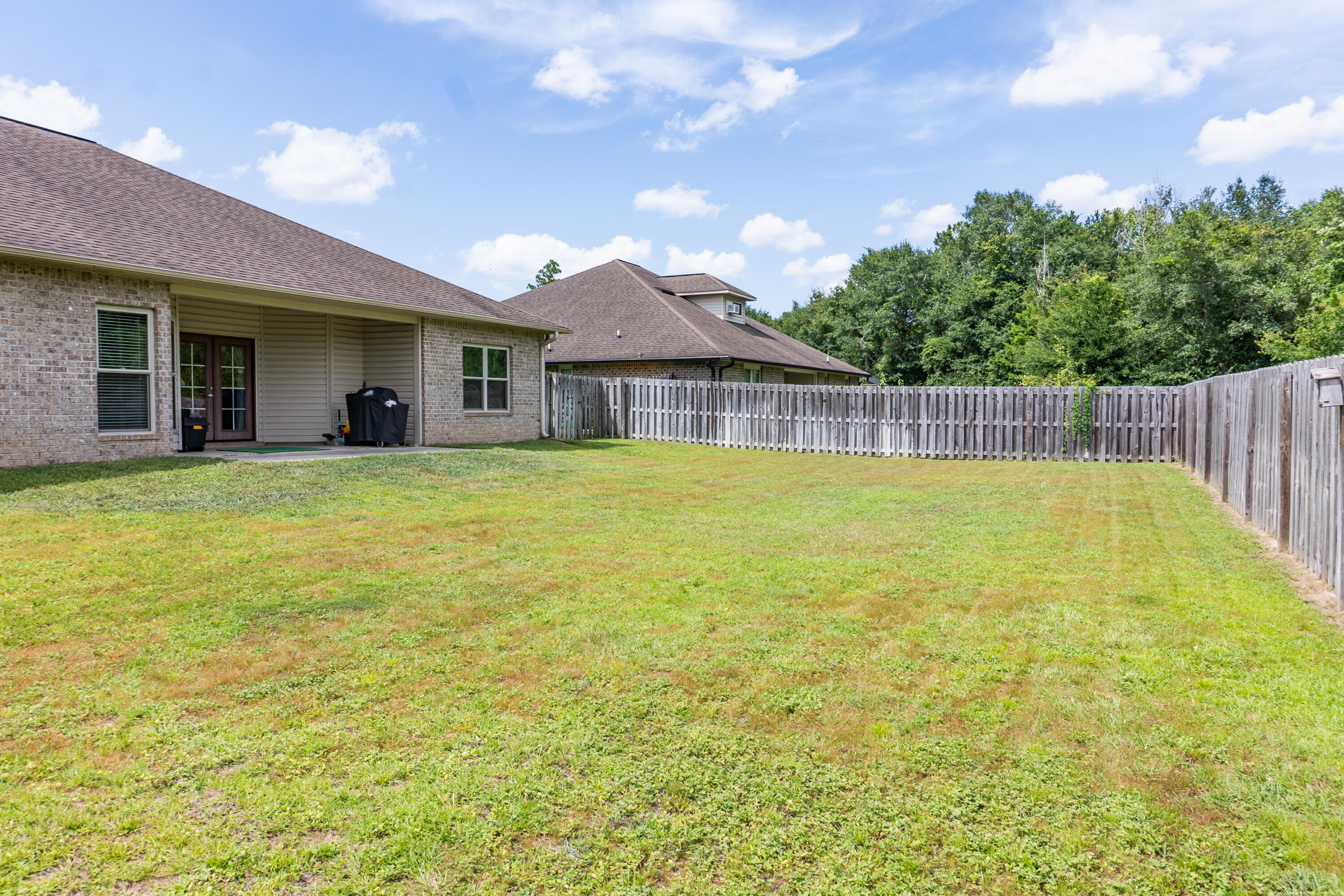 4517 Beth Circle Crestview, FL 32539 - Photo 44 of 45 a view of a house with a swimming pool and a yard