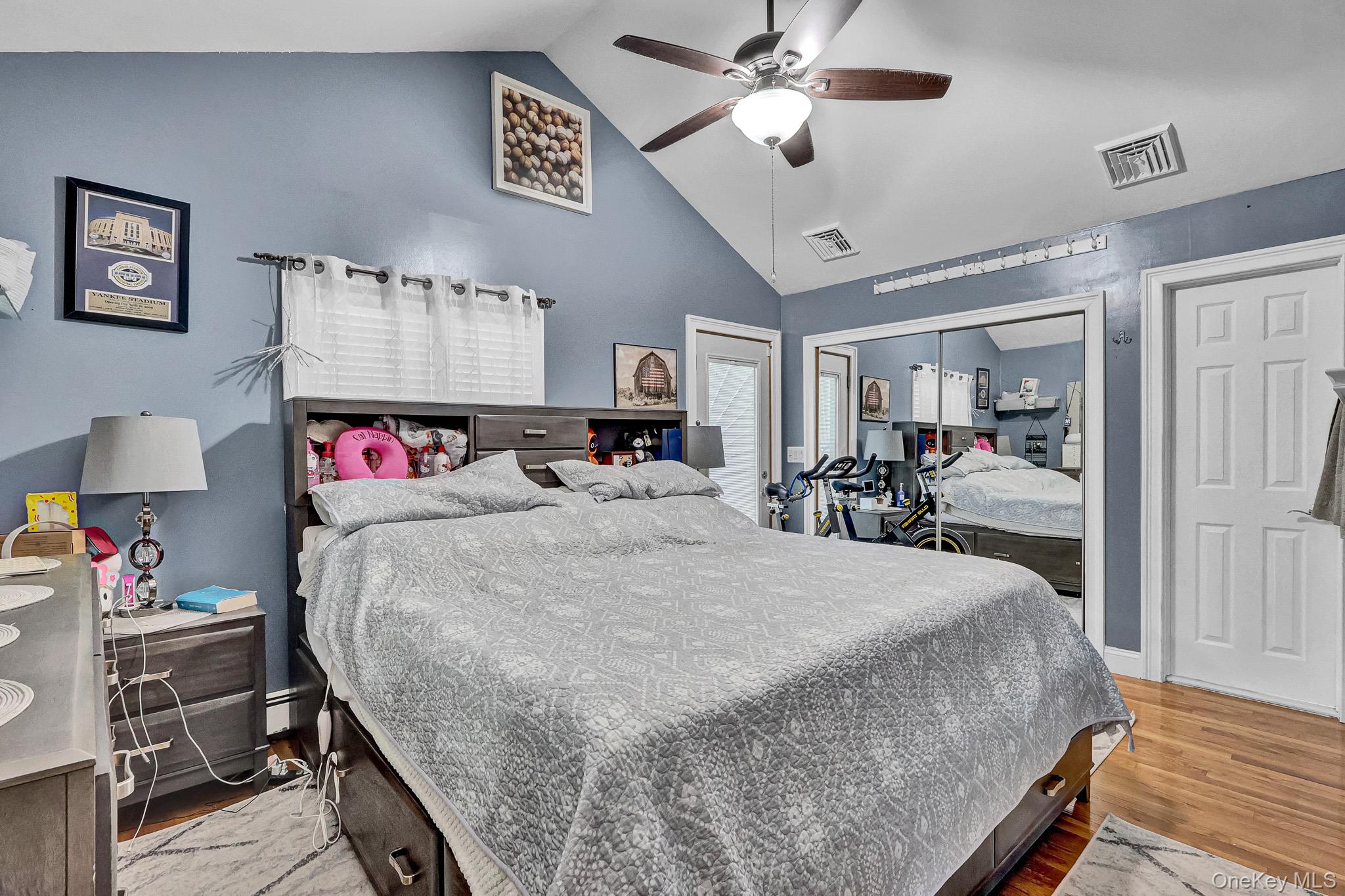 98 Granny Road Farmingville, NY 11738 - Photo 14 of 24 a bedroom with a bed and a chandelier
