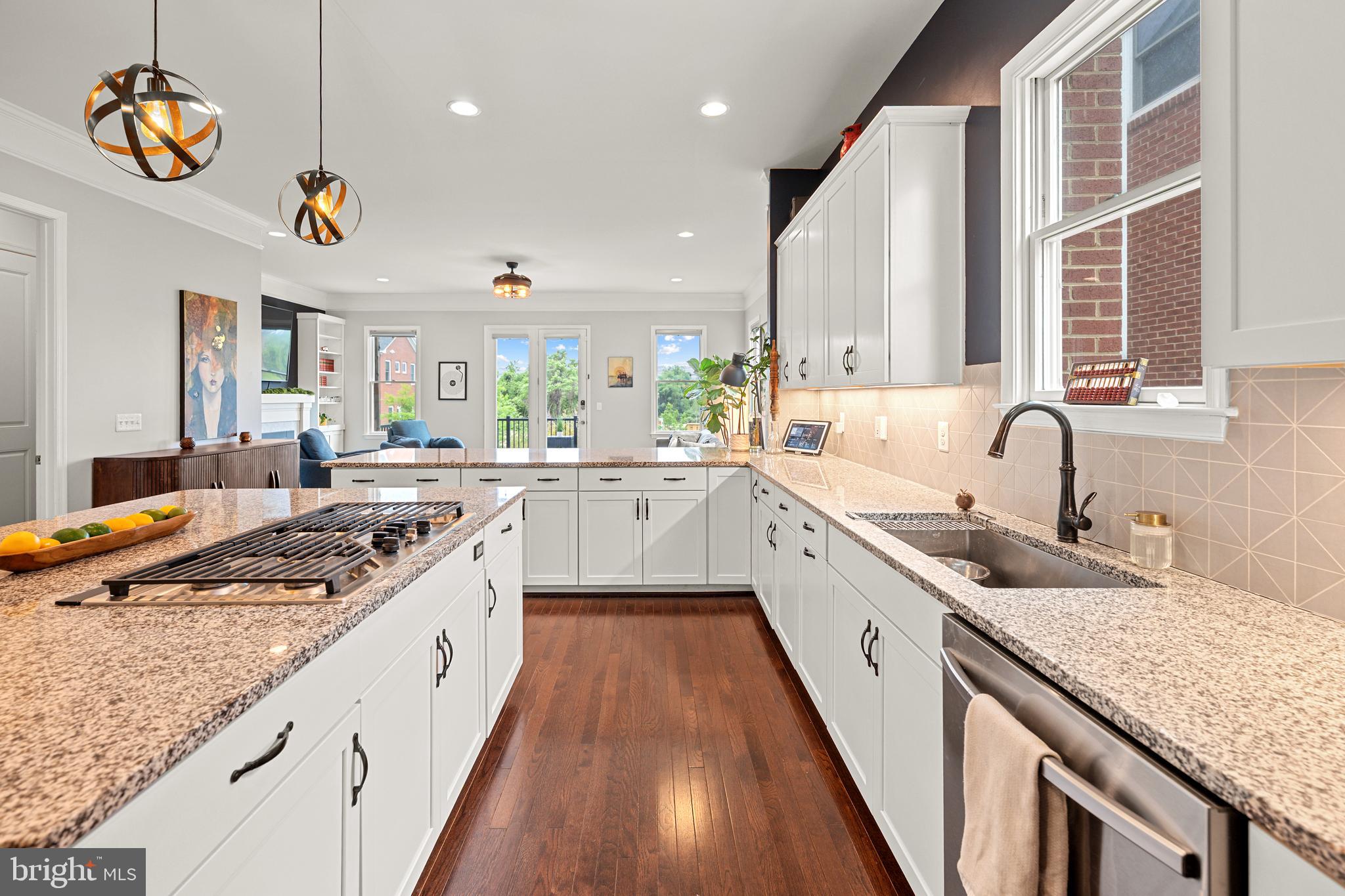 8459 Reformatory Way Lorton, VA 22079 - Photo 13 of 78 a large kitchen with stainless steel appliances granite countertop a sink a stove and a wooden floors