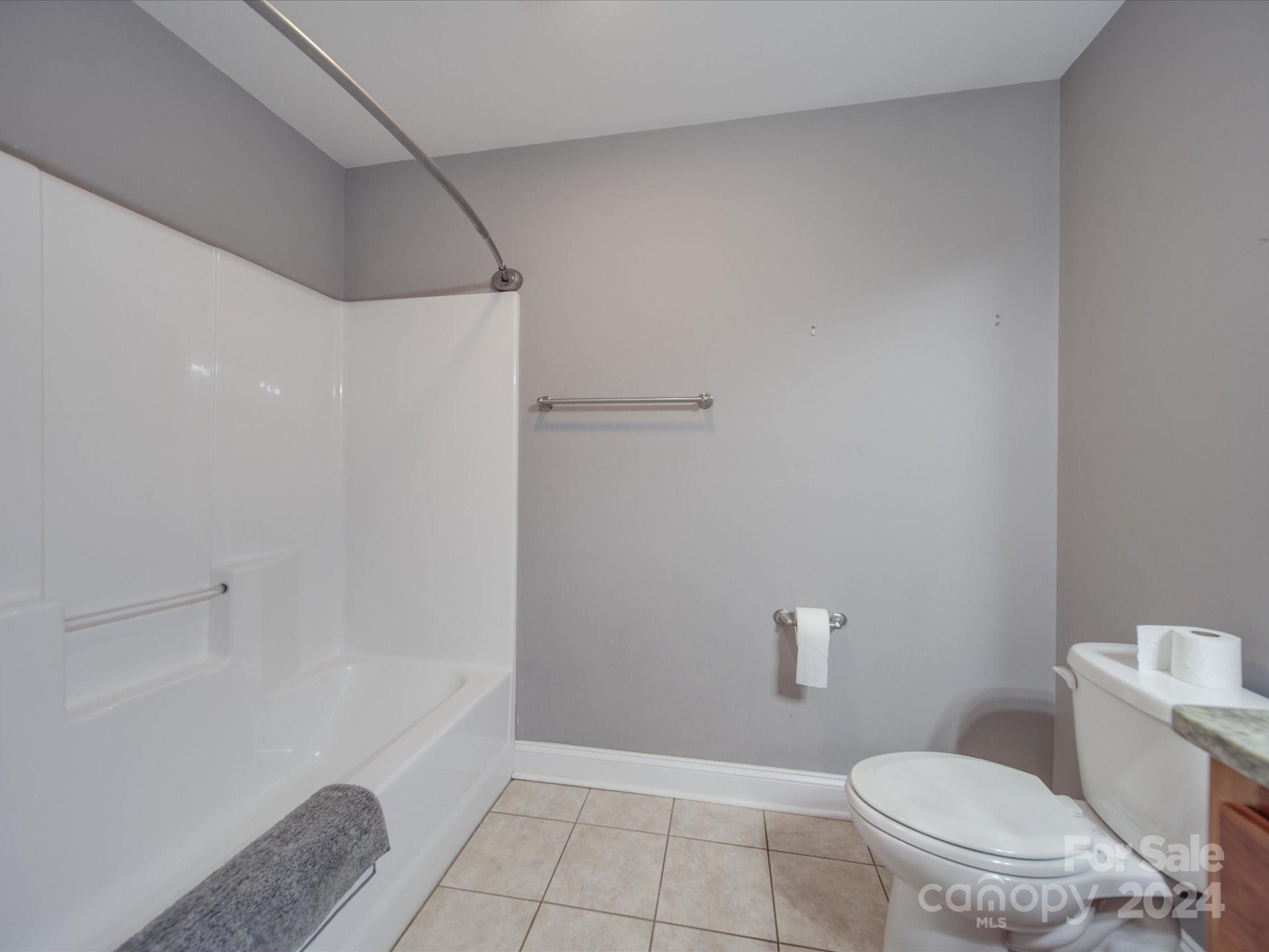 345 Springlake Road York, SC 29745 - Photo 16 of 17 a bathroom with a granite countertop bathtub and toilet
