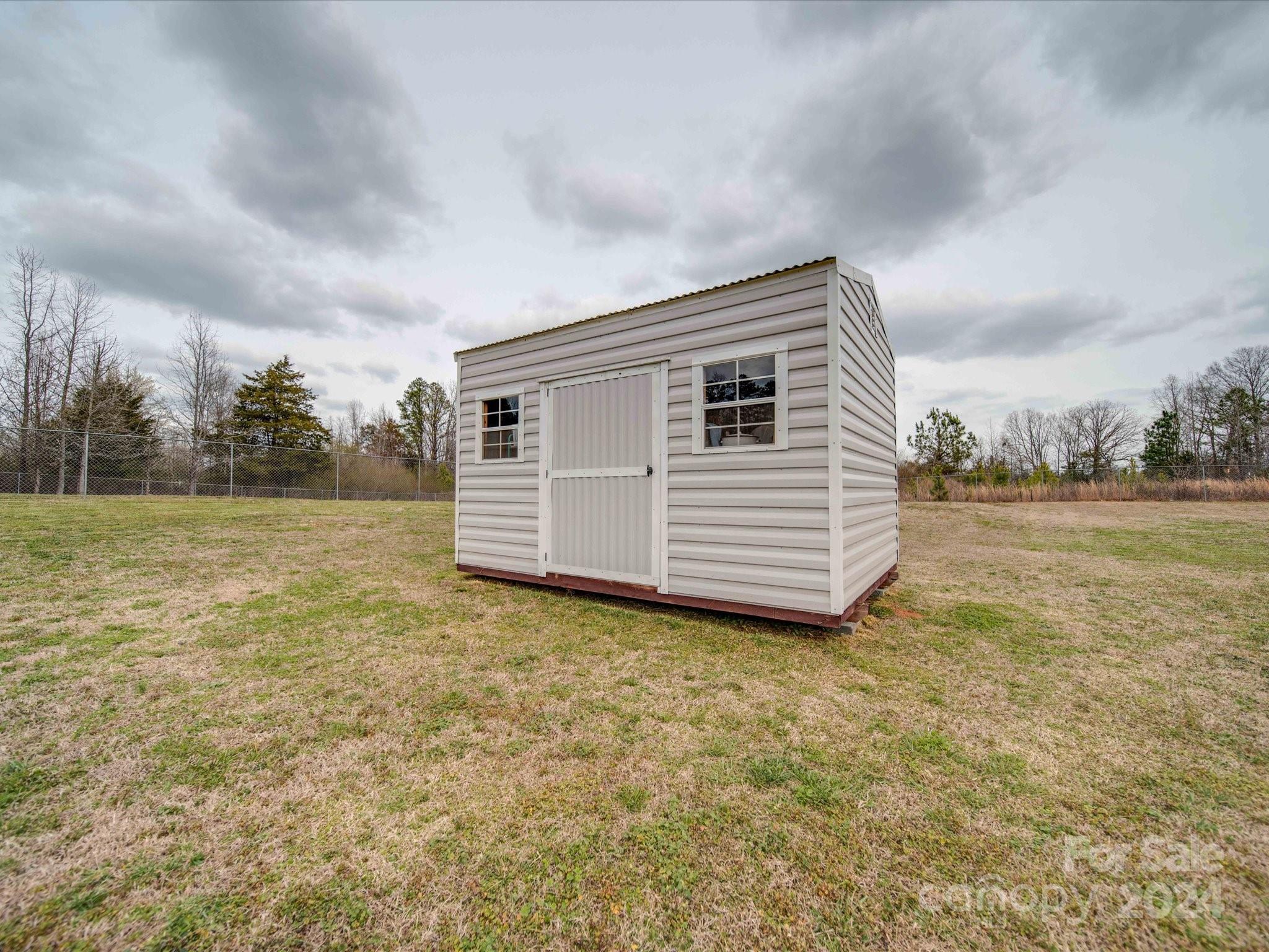 345 Springlake Road York, SC 29745 - Photo 4 of 17 a backyard of a house with a yard and garage
