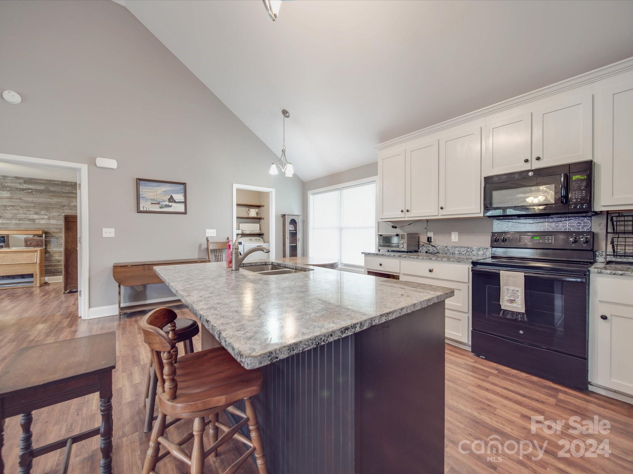 345 Springlake Road York, SC 29745 - Photo 6 of 17 a kitchen with stainless steel appliances granite countertop a stove top oven a sink dishwasher and cabinets with wooden floor