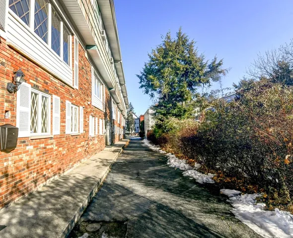 a view of a pathway with a house in the background