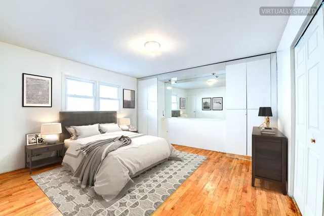 a bedroom with a bed and a painting on the wall