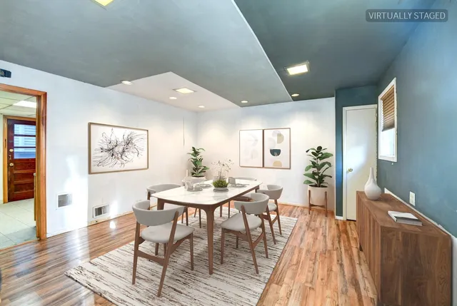 a view of a dining room with furniture and wooden floor