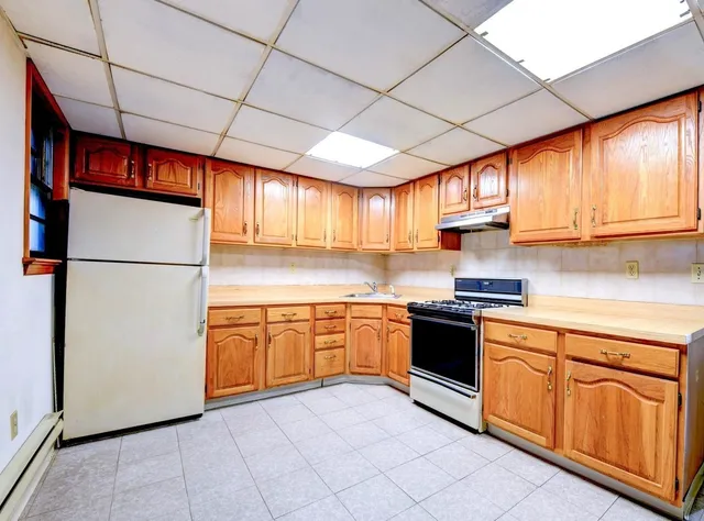 a kitchen with granite countertop stainless steel appliances a refrigerator a sink a stove a microwave and cabinets