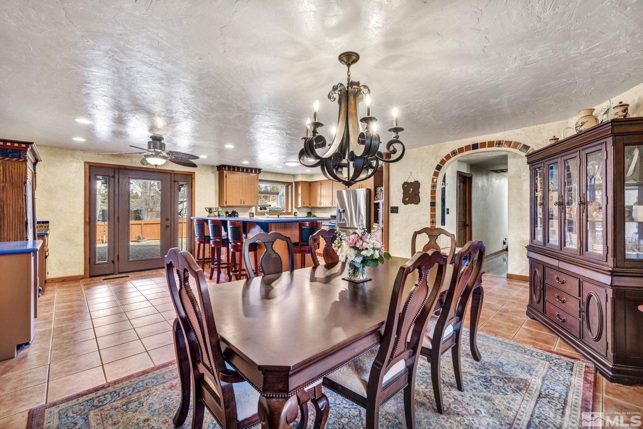 14230 Riata Circle Reno, NV 89521 - Photo 11 of 40 a dining room with furniture a chandelier and wooden floor