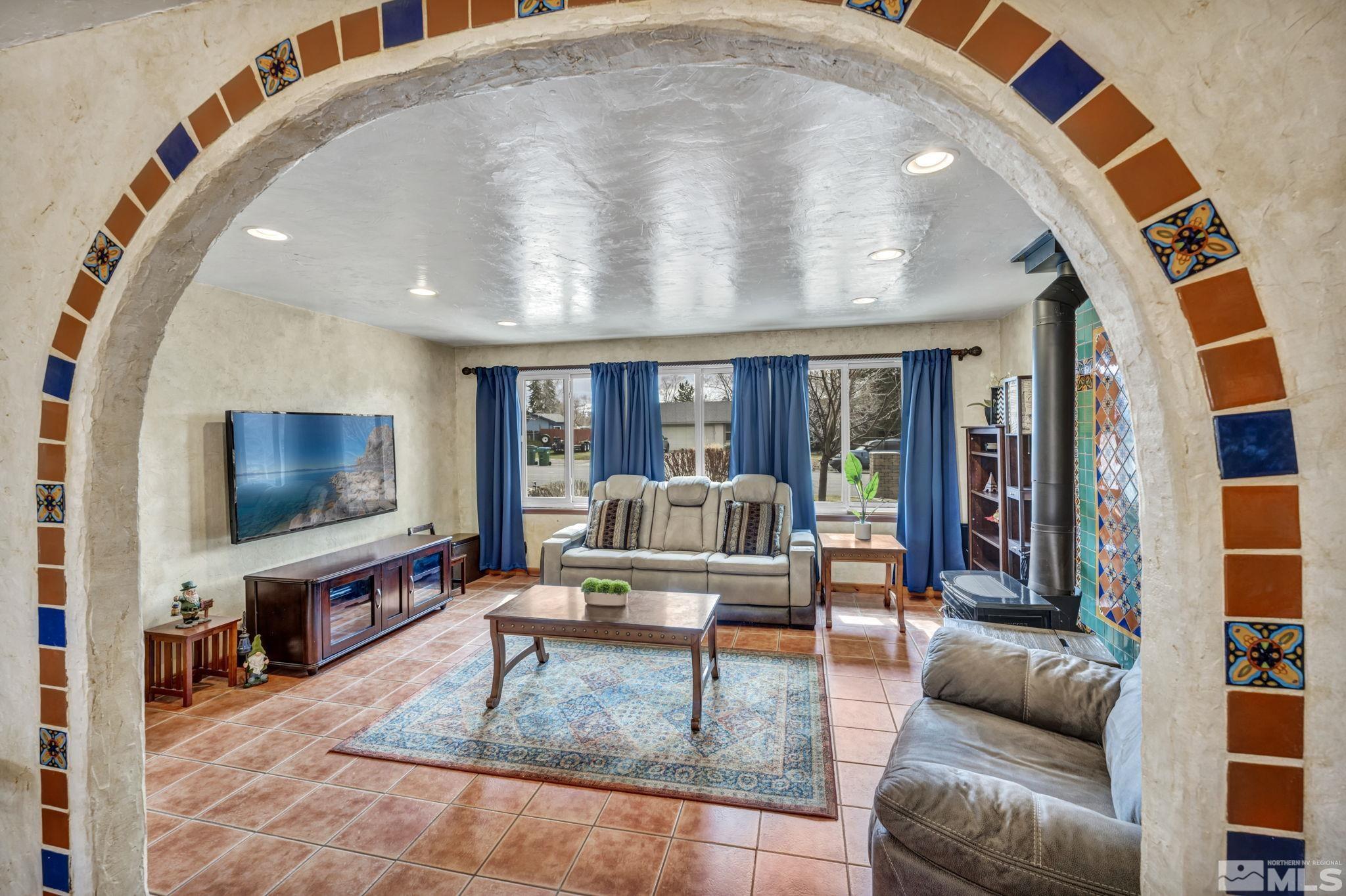 14230 Riata Circle Reno, NV 89521 - Photo 13 of 40 a living room with furniture and a flat screen tv