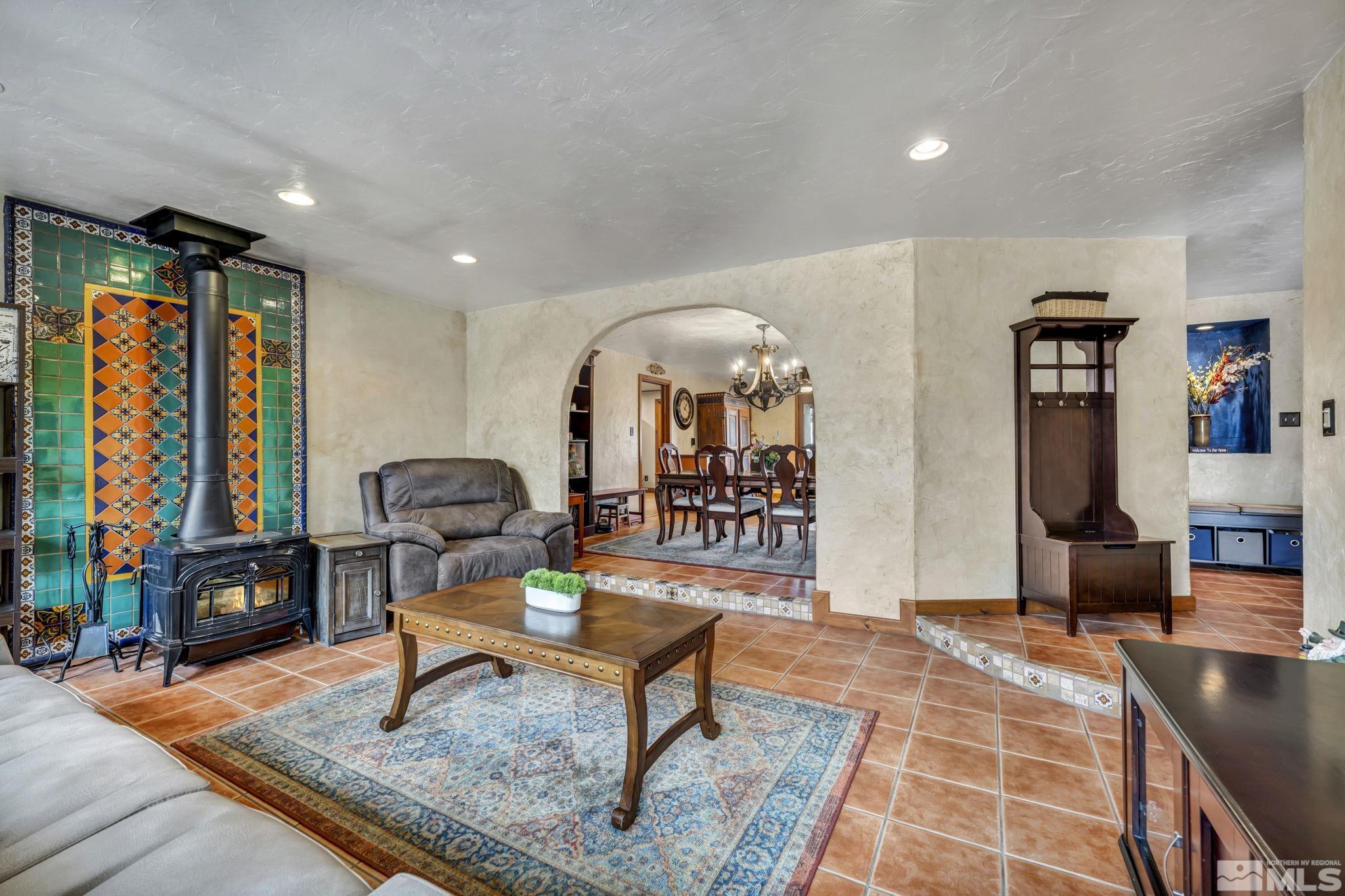 14230 Riata Circle Reno, NV 89521 - Photo 16 of 40 a living room with furniture a rug and a flat screen tv