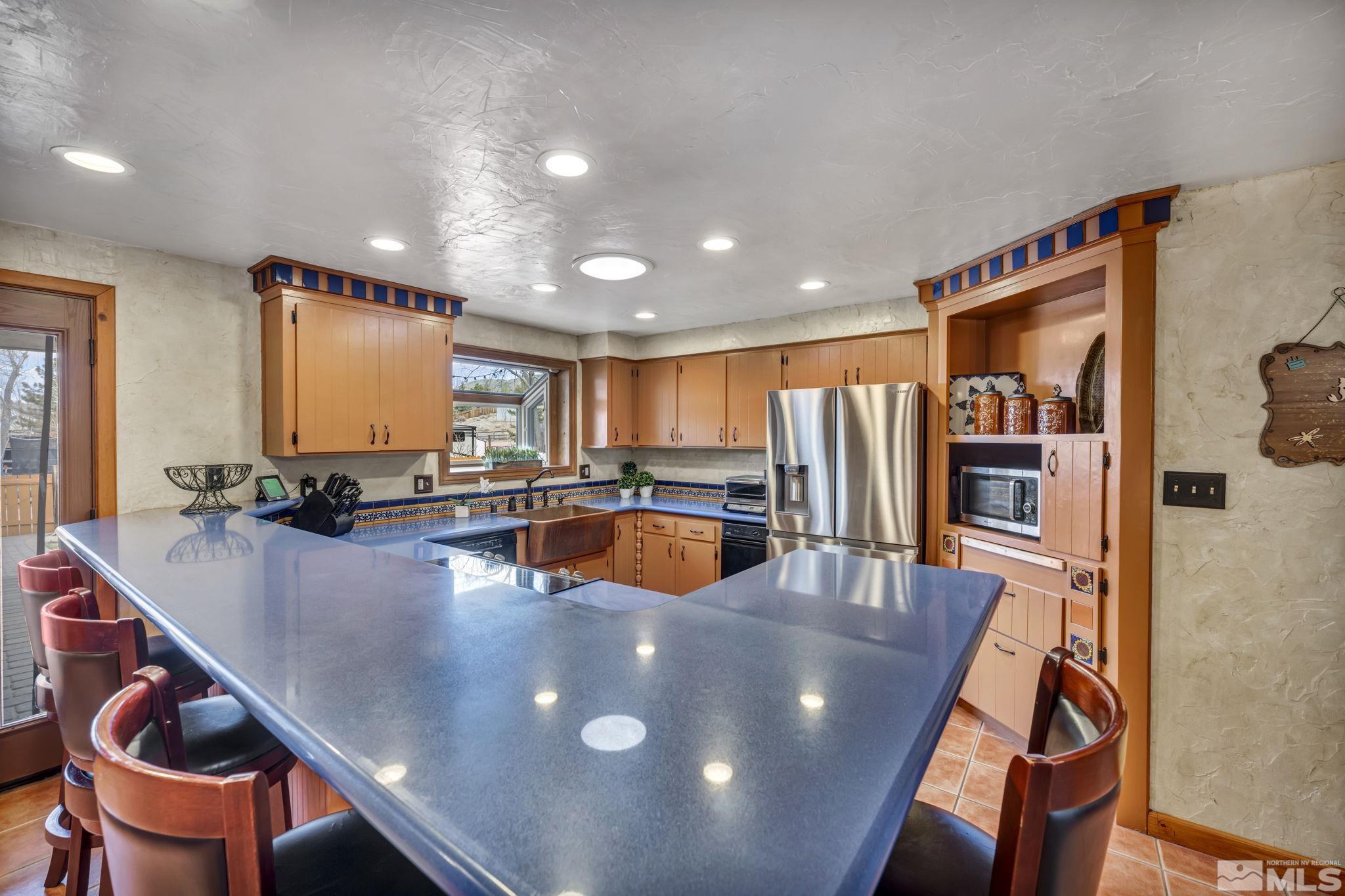 14230 Riata Circle Reno, NV 89521 - Photo 8 of 40 a view of a dining room with furniture and a kitchen