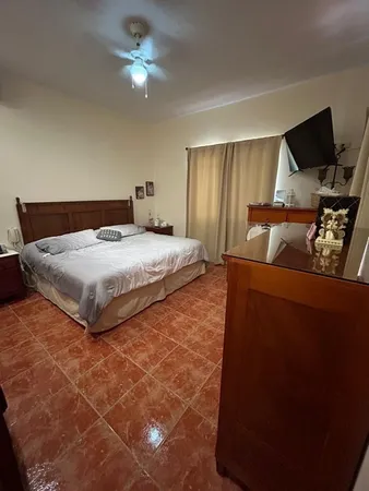 a bedroom with a bed and a ceiling fan