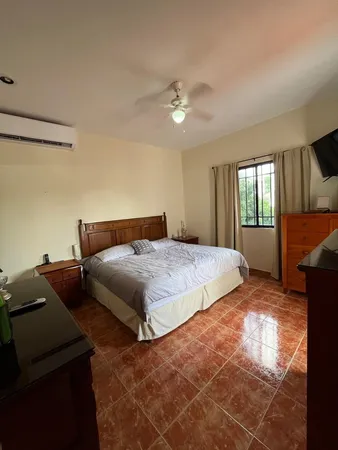a bedroom with a bed and a ceiling fan