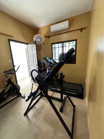 a room with gym equipment and equipment