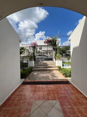 a front view of a house with a garden