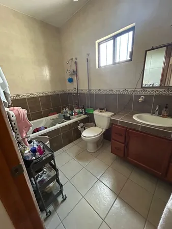 a hallway with a large window and dresser