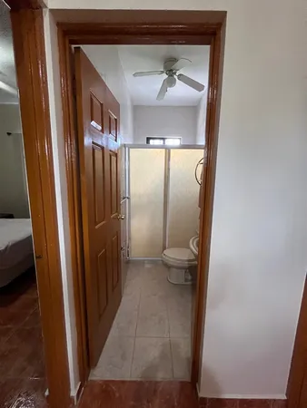 a view of a bathroom from a corridor