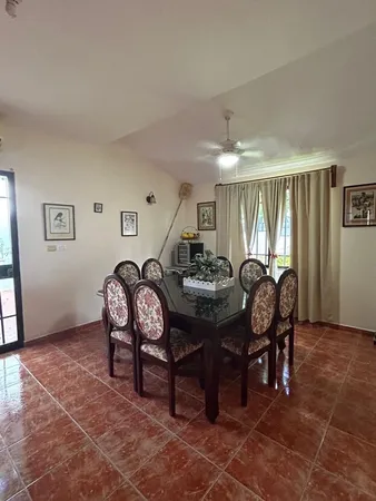 a view of a dining room with furniture and window
