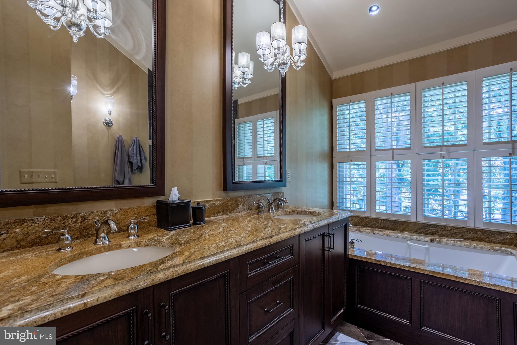63 Raisin Tree Circle Baltimore, MD 21208 - Photo 34 of 57 a bathroom with a granite countertop sink and a large mirror