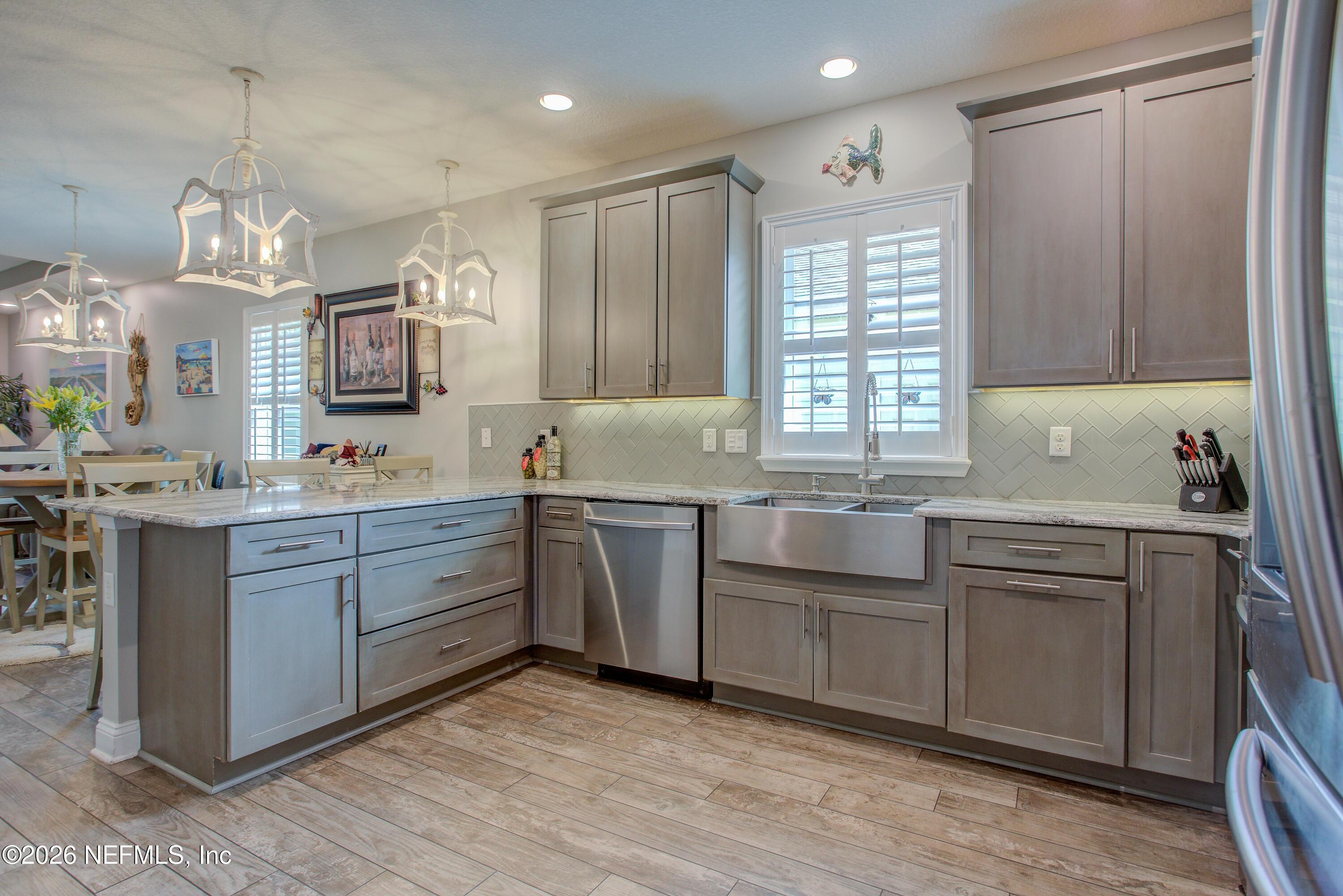 394 Balearics Drive St. Augustine, FL 32086 - Photo 8 of 26 a kitchen with kitchen island granite countertop a sink cabinets and stainless steel appliances