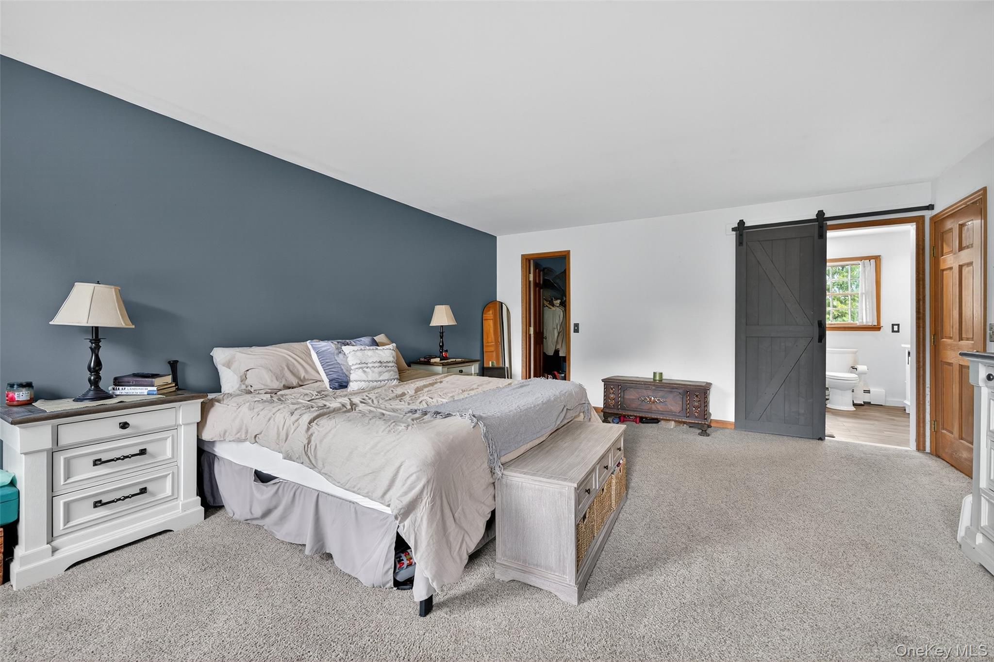 214 Dubois Road Gardiner, NY 12561 - Photo 20 of 38 a spacious bedroom with a bed and a lamp