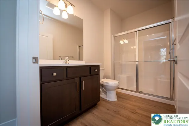a bathroom with a toilet a sink and mirror