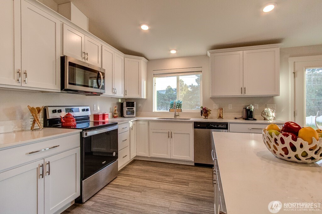 27 Jonagold Lane Manson, WA 98831 - Photo 9 of 32 a kitchen with stainless steel appliances granite countertop a stove sink microwave and cabinets