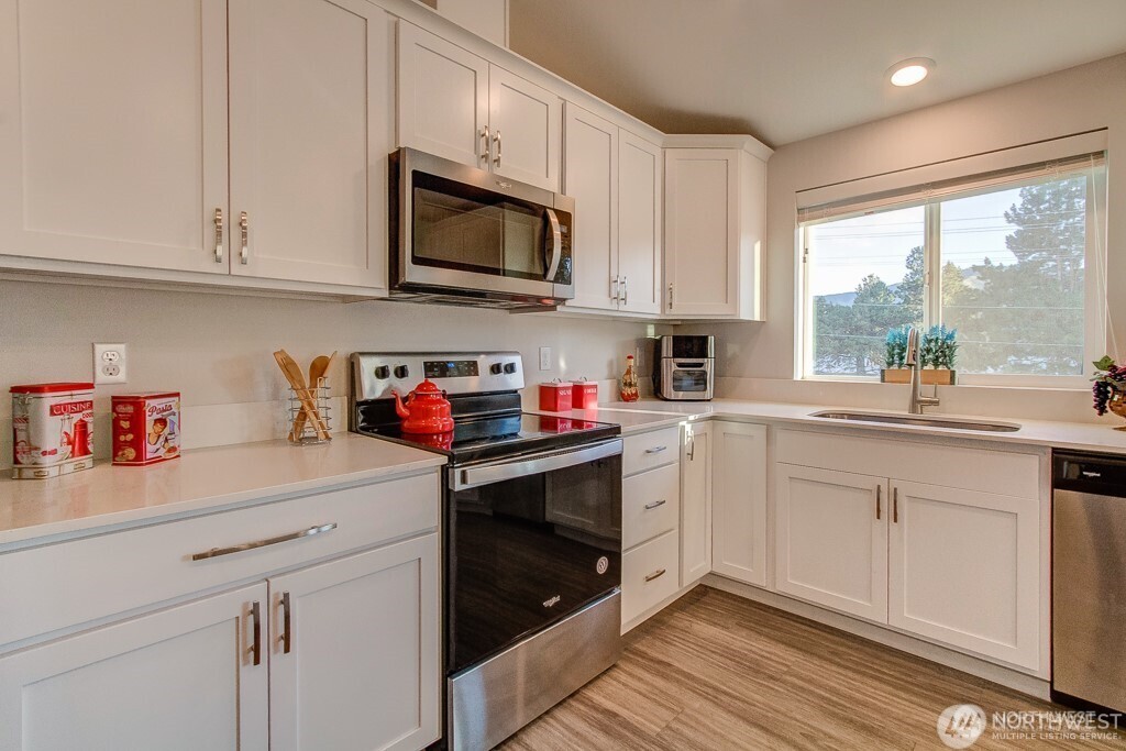 27 Jonagold Lane Manson, WA 98831 - Photo 10 of 32 a kitchen with stainless steel appliances granite countertop white cabinets a sink and a window