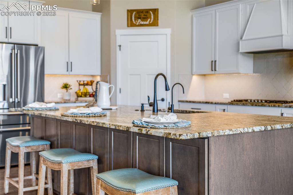 2960 Longhorn Rdg View Peyton, CO 80831 - Photo 13 of 49 a kitchen with a sink and a stove
