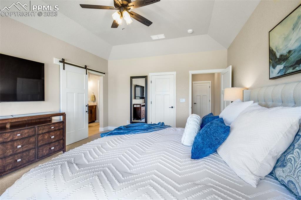 2960 Longhorn Rdg View Peyton, CO 80831 - Photo 19 of 49 a bedroom with a bed and a flat screen tv