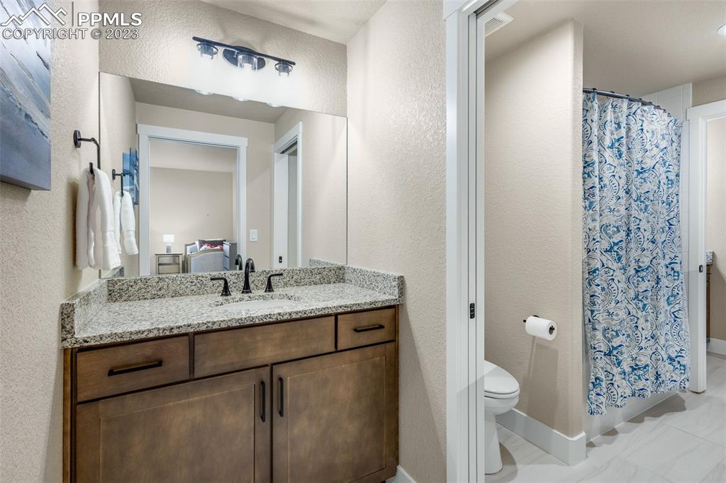 2960 Longhorn Rdg View Peyton, CO 80831 - Photo 33 of 49 a bathroom with a granite countertop sink toilet and shower