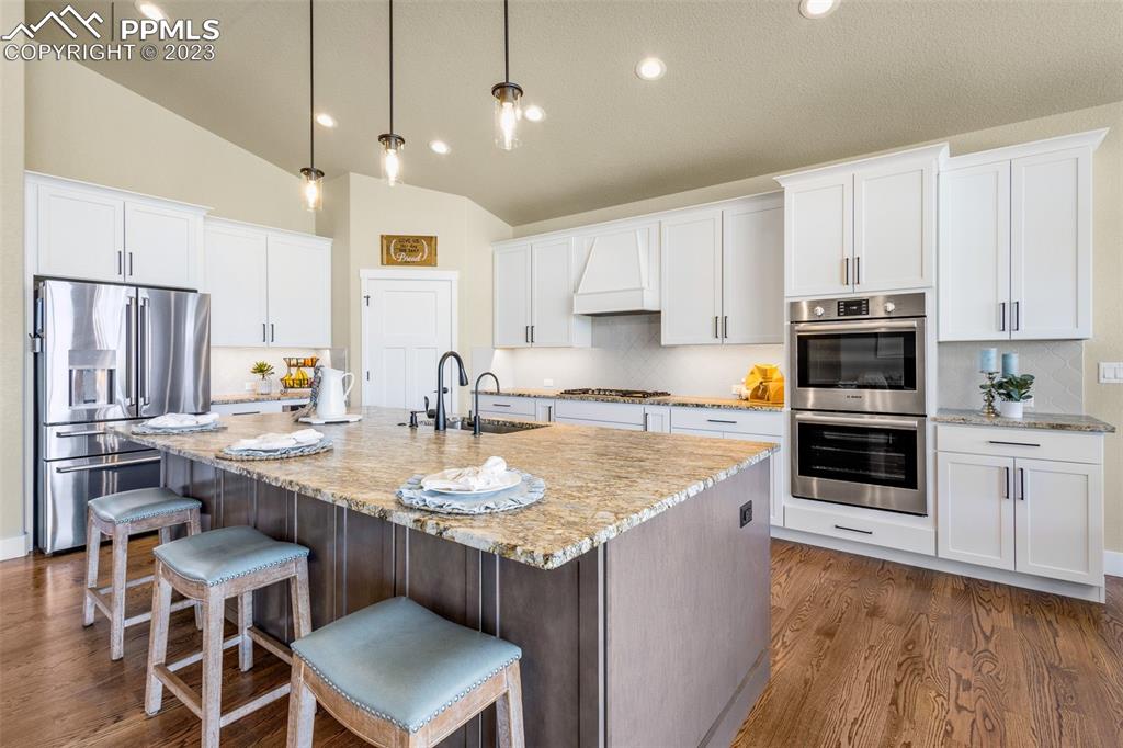 2960 Longhorn Rdg View Peyton, CO 80831 - Photo 10 of 49 a kitchen with stainless steel appliances granite countertop a sink stove and refrigerator