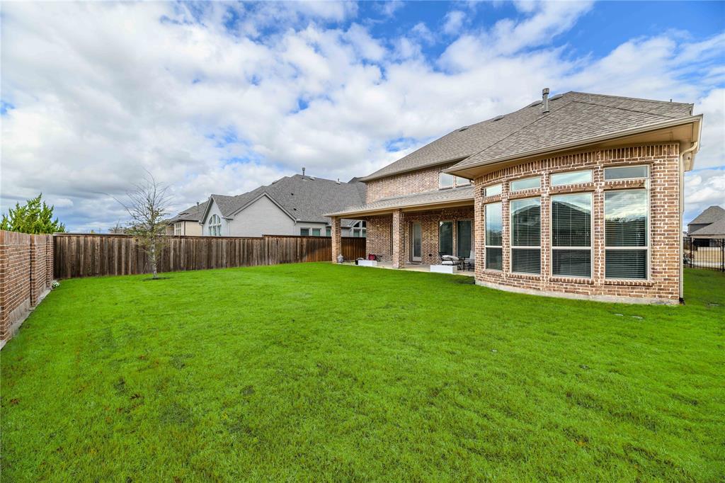 16541 Sweetgum Road Frisco, TX 75033 - Photo 25 of 26 Expansive green lawn with a full brick exterior featuring a bay window wall