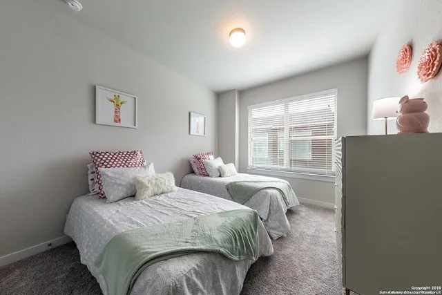 a bedroom with bed and a window