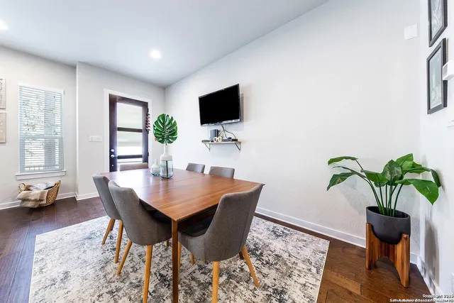 a living room with furniture potted plant and a flat screen tv