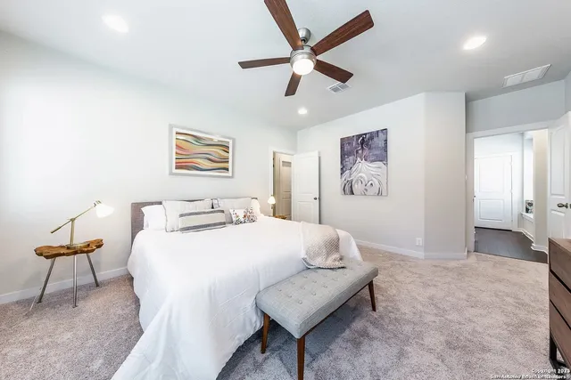 a bedroom with a bed and a chair