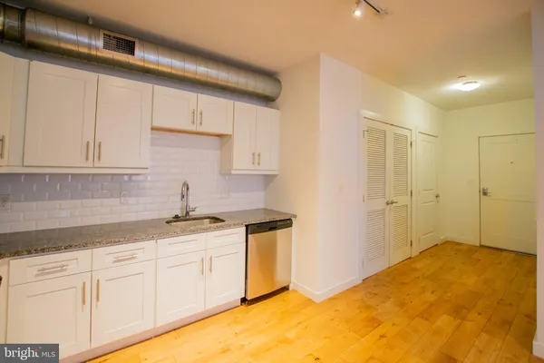 a kitchen with a sink and cabinets